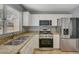 Bright kitchen boasting granite counters and stainless appliances, complimented by a window for natural light at 2430 Sungold Dr, Las Vegas, NV 89134