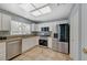 Well-equipped kitchen with stainless steel appliances, tile flooring, granite counters, and bright lighting at 2430 Sungold Dr, Las Vegas, NV 89134
