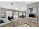 Bright living room with wood floors, ceiling fan, neutral walls, and sliding glass doors to the backyard at 2430 Sungold Dr, Las Vegas, NV 89134