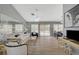 Cozy living room with wood floors, neutral walls, a ceiling fan, and sliding glass doors leading to the outdoor patio at 2430 Sungold Dr, Las Vegas, NV 89134
