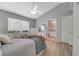 This main bedroom offers generous natural light, a ceiling fan, and an ensuite bathroom for convenience at 2430 Sungold Dr, Las Vegas, NV 89134