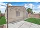 Backyard with a pergola, turf, and a beige-painted home exterior at 2432 Shady Hill Ave, Las Vegas, NV 89106