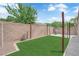 View of landscaped backyard with a grass patch and a brick perimeter at 2432 Shady Hill Ave, Las Vegas, NV 89106