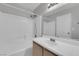 Bathroom featuring a shower and tub combination, vanity and framed mirror at 2432 Shady Hill Ave, Las Vegas, NV 89106