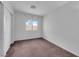 Simple bedroom with neutral carpet and a view of the yard from the window at 2432 Shady Hill Ave, Las Vegas, NV 89106