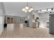 Open layout joining the kitchen and living space, featuring tile flooring, stainless steel appliances, and ample natural light at 2432 Shady Hill Ave, Las Vegas, NV 89106