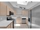 Well-lit kitchen showcasing stainless steel appliances, ample countertop space, and modern track lighting at 2432 Shady Hill Ave, Las Vegas, NV 89106