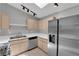 Contemporary kitchen featuring stainless steel appliances, ample counter space, and modern lighting fixtures at 2432 Shady Hill Ave, Las Vegas, NV 89106