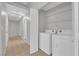 Laundry room includes a full-size washer and dryer with wire shelving at 2432 Shady Hill Ave, Las Vegas, NV 89106