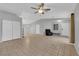 Bright living room with tile floor, ceiling fan, and natural light, featuring access to the backyard at 2432 Shady Hill Ave, Las Vegas, NV 89106