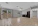 Large open living area with access to the backyard, tile flooring, and a neutral color palette at 2432 Shady Hill Ave, Las Vegas, NV 89106