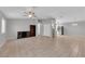 Spacious living room featuring tile flooring, ceiling fan, and neutral paint, seamlessly connecting living and kitchen areas at 2432 Shady Hill Ave, Las Vegas, NV 89106