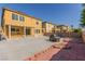 Spacious backyard with a large patio, brick accents, and a clear view of the blue sky at 2621 Rainbow Glow St, North Las Vegas, NV 89030