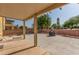 Covered patio with a concrete slab, brick wall, and shade for enjoying outdoor living at 2621 Rainbow Glow St, North Las Vegas, NV 89030