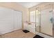 Bright bathroom featuring a shower with glass door and sliding closet doors at 2621 Rainbow Glow St, North Las Vegas, NV 89030