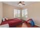 Bedroom featuring hard wood floors, a ceiling fan, and two bright windows at 2621 Rainbow Glow St, North Las Vegas, NV 89030
