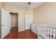 Bedroom room with a crib and hard wood floors at 2621 Rainbow Glow St, North Las Vegas, NV 89030