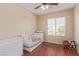 Bedroom room with a crib and a bright window that lets in natural light at 2621 Rainbow Glow St, North Las Vegas, NV 89030