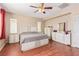 Bright bedroom featuring hardwood floors, a ceiling fan, and modern furnishings at 2621 Rainbow Glow St, North Las Vegas, NV 89030