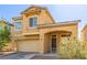 Inviting two-story home featuring a two-car garage and covered front porch at 2621 Rainbow Glow St, North Las Vegas, NV 89030