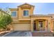 Inviting two-story home featuring a two-car garage and covered front porch at 2621 Rainbow Glow St, North Las Vegas, NV 89030