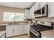 Updated kitchen with stainless steel appliances and granite countertops at 2621 Rainbow Glow St, North Las Vegas, NV 89030