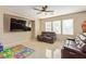 Comfortable living room with tile floors, a ceiling fan, and leather sofas at 2621 Rainbow Glow St, North Las Vegas, NV 89030