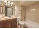 Neutral bathroom featuring a vanity with marble countertop and a tiled shower-tub combo at 2761 Carnation Ln # 1, Henderson, NV 89074