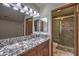Bathroom featuring granite countertop and a walk-in shower with custom tile at 2761 Carnation Ln # 1, Henderson, NV 89074