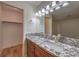 Bathroom with granite countertop, wood floors, and a walk-in closet at 2761 Carnation Ln # 1, Henderson, NV 89074