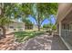 Scenic exterior view showcasing a lush green lawn, mature trees, and well-maintained landscaping surrounding the building at 2761 Carnation Ln # 1, Henderson, NV 89074