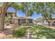 Exterior of the property with mature landscaping and a covered parking area at 2761 Carnation Ln # 1, Henderson, NV 89074