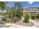 Charming front entrance with mature trees and desert landscaping, offering a tranquil approach to the home at 2761 Carnation Ln # 1, Henderson, NV 89074