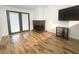 Bright living room featuring laminate floors, brick fireplace, and double doors leading to patio at 2761 Carnation Ln # 1, Henderson, NV 89074