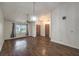 Open living area with wood floors, a ceiling fan, natural light from the window, and multiple entrances at 2761 Carnation Ln # 1, Henderson, NV 89074