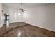 Bright living room featuring beautiful wood floors, a ceiling fan, and fresh white paint at 2761 Carnation Ln # 1, Henderson, NV 89074