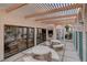 Inviting outdoor patio with stone table and benches, a built-in barbecue, and a pergola offering shaded seating at 2761 Carnation Ln # 1, Henderson, NV 89074