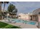 Inviting community pool and hot tub area with lounge chairs, palm trees, and well-maintained landscaping at 2761 Carnation Ln # 1, Henderson, NV 89074