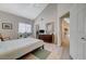 Spacious bedroom with light wood floors, a large window, and a view into the hallway at 2925 Wigwam Pkwy # 123, Henderson, NV 89074