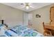 Cozy bedroom with a ceiling fan, carpeted floor, a desk, and a bed with patterned bedding at 2925 Wigwam Pkwy # 123, Henderson, NV 89074
