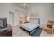 Well-lit bedroom with a high ceiling, a comfortable bed, and a charming rocking chair at 2925 Wigwam Pkwy # 123, Henderson, NV 89074
