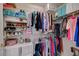 Walk-in closet with organized storage solutions for clothes, shoes, and accessories at 2925 Wigwam Pkwy # 123, Henderson, NV 89074