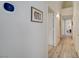 Hallway featuring wood-look laminate flooring, neutral wall color, a smart thermostat, and access to other rooms at 2925 Wigwam Pkwy # 123, Henderson, NV 89074