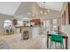 Open kitchen with breakfast bar and modern lighting, seamlessly connected to the dining area at 2925 Wigwam Pkwy # 123, Henderson, NV 89074