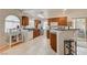 A kitchen showcases wood cabinetry, a breakfast bar, stainless steel appliances, and sliding glass door to patio at 2925 Wigwam Pkwy # 123, Henderson, NV 89074
