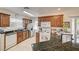 Charming kitchen featuring granite countertops, stainless steel appliances, wood cabinetry, and tile floors at 2925 Wigwam Pkwy # 123, Henderson, NV 89074