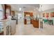 Bright kitchen featuring wood cabinetry, a breakfast bar, tile floors, stainless steel appliances, and dining area at 2925 Wigwam Pkwy # 123, Henderson, NV 89074