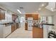 Spacious kitchen featuring wood cabinetry, a breakfast bar, stainless steel appliances, and tile flooring at 2925 Wigwam Pkwy # 123, Henderson, NV 89074