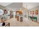 Bright kitchen featuring wood cabinetry, a breakfast bar, tile floors, and a dining area with sliding glass door at 2925 Wigwam Pkwy # 123, Henderson, NV 89074
