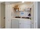 Convenient laundry room with modern washer and dryer, and storage shelves at 2925 Wigwam Pkwy # 123, Henderson, NV 89074